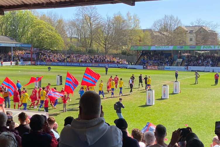 Aldershot Town and Woking enter the pitch for their FA Trophy semi-final