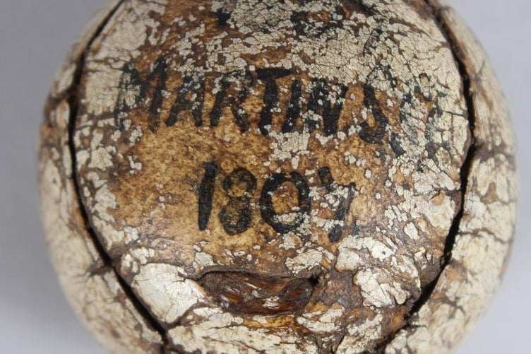 An old leather-bound featherie golf ball due to go under the hammer has presented a conundrum for auctioneers - and it is set to fetch up to £10k. Photo released April 27 2025. The early leather-bound feather golf ball was consigned for sale from a house move in Old Woking in Surrey and John Nicholsons auctioneers will sell it on May 14. The auctioneers said the family heirloom is inscribed stamped King James VI Club. Perth to one side, and 1807 Martins?? 1807 to the other the inscriptions appearing under much wear and tear to the ball.
