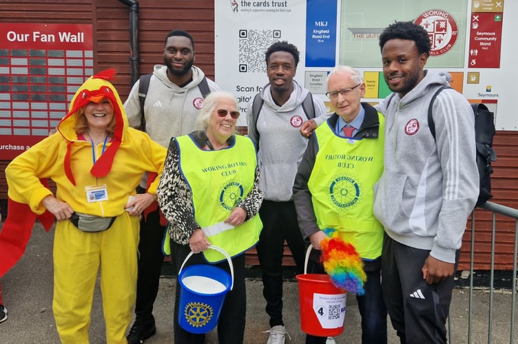 Collectors from Rotary Club of Woking (Teresa Stedman, Carol Cheesman and Keith Tatlock) with players from Woking Football Club
