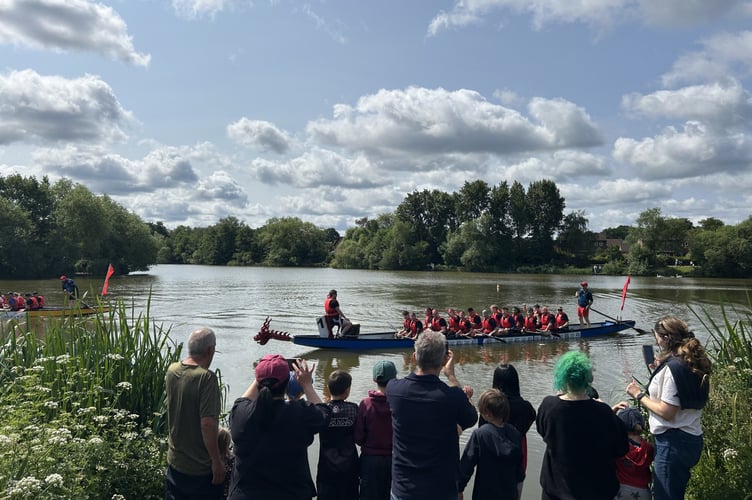Dragon Boat on lake and spectators