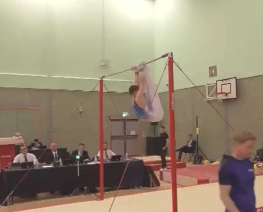 A Woking gymnast starts to rotate on the high bar, Basildon Sporting Village, June 7th and 8th 2025.