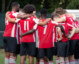 Guildford City players in huddle, 2024-25 season.