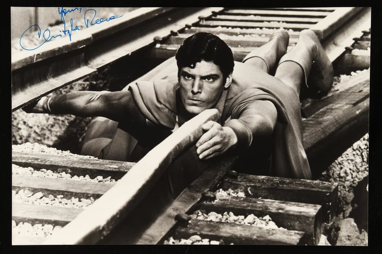 The signed photo of Christopher Reeve in Superman.