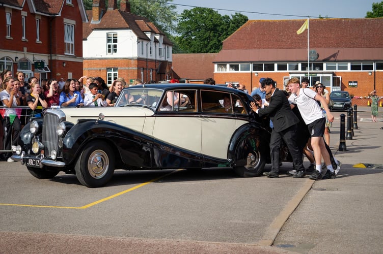 Watching students give the Rolls Royce a push to get it onto the Parade Square for the grand entrance by its passengers
