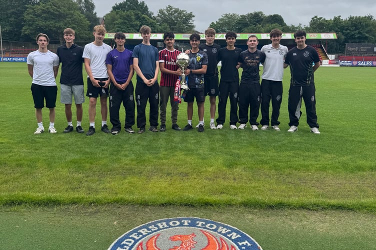 Students got the chance to hold the coveted Isuzu FA Trophy while volunteering at Aldershot Town Football Club.