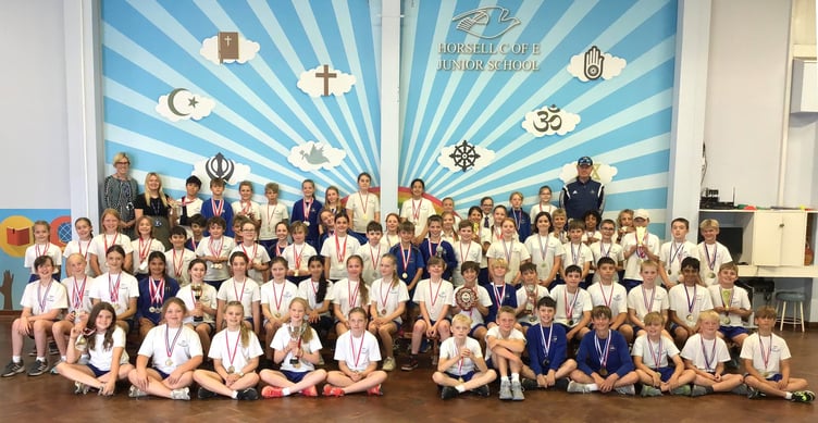 Pupils at Horsell C of E Junior School celebrate a record-breaking year of sporting success across rugby, cricket, netball, athletics, swimming and more