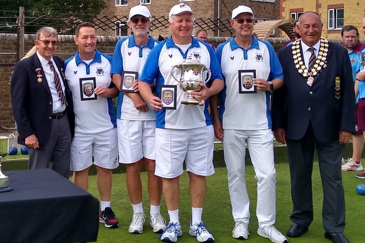 The West Byfleet Bowls Club team receiving their trophy and badges