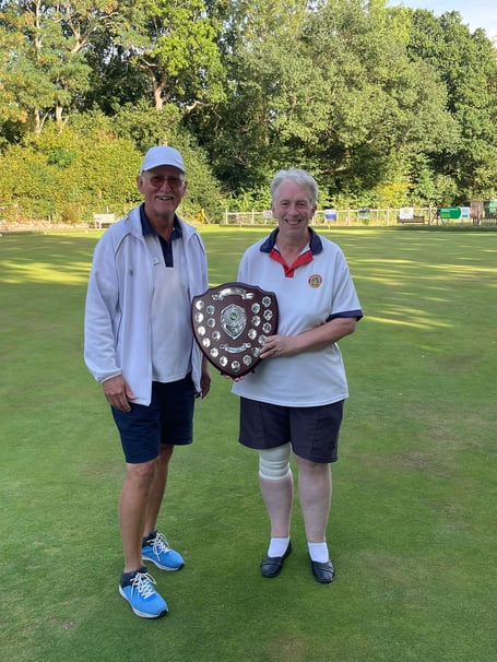 Angela Boarer receiving the trophy from Woking Park captain Andrew Smith