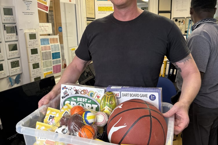 Rewarding hard work: a team member accepts their hamper for the fundraising challenge.