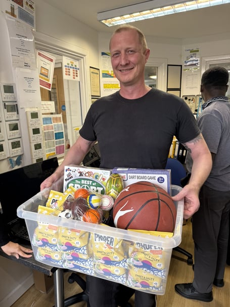 Rewarding hard work: a team member accepts their hamper for the fundraising challenge.