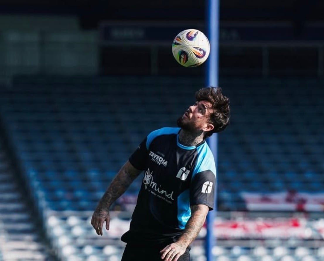 Jay Rosa performing football freestyle on a stadium pitch