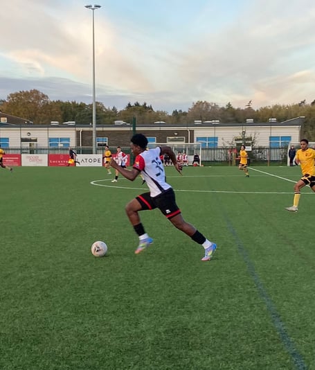 Roshan Kigozi drives forward for Woking (Photo: Holly Porter)