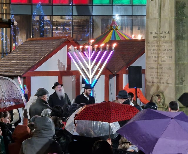 Crowds gather to honour historic menorah lighting