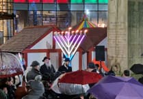 Crowds gather to honour historic menorah lighting