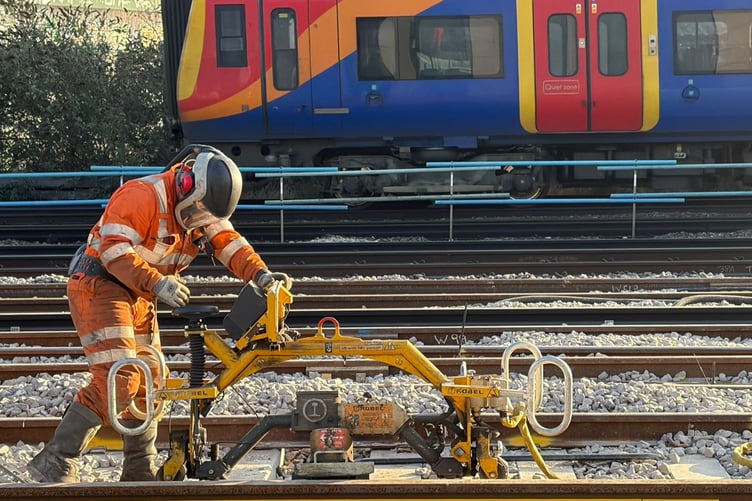 Work at Queenstown Road with a SWR train passing.