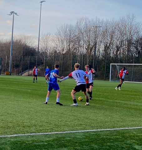 Josh Solecki drives forward for Woking (Photo: Holly Porter)
