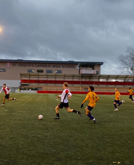 Tom Dryer drives forward for Woking (Photo: Holly Porter)