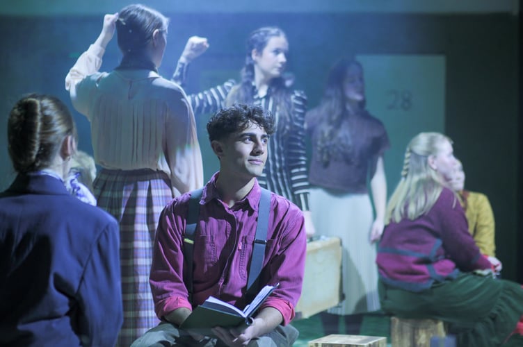 Enjoying his precious book of discarded photobooth photographs, Nino (Elliot Watson).