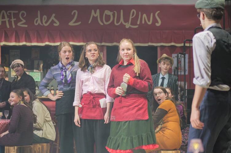 Amelie in the throws of trying to matchmake her co-worker Georgette with Joseph, a patron of the café (centre) Emilia Wilkins (Suzanne); Jessica Murphy (Gina) and Kate Brazendale (Amelie).