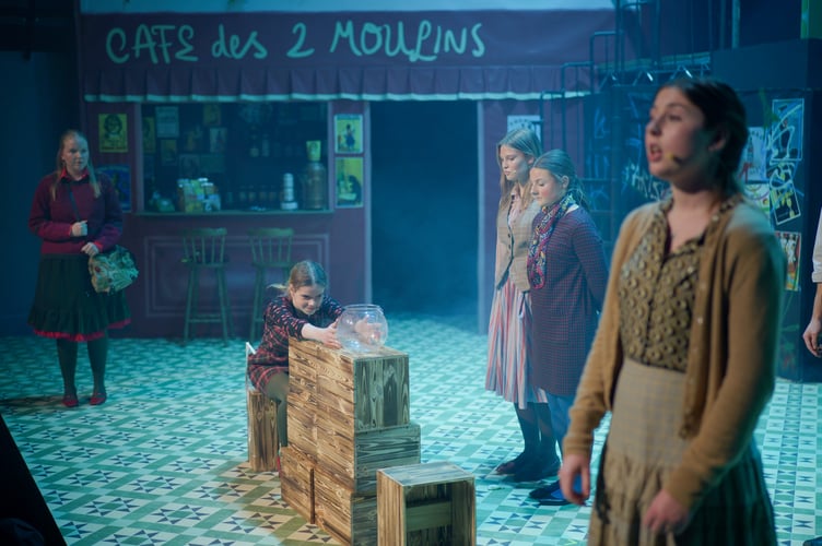 Together with her best friend the goldfish, the young Amelie (Siena Phipps). Also pictured are (left to right): the older Amelie (Kate Brazendale), Emily Hunter, Emilia Wilkins and Chloe Hudd.