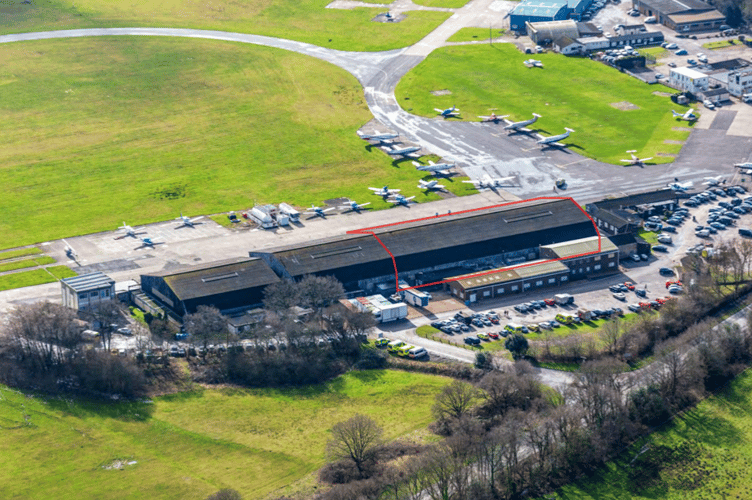 The aircraft hangar at Fairoaks Airport, with the red outline showing where the new indoor padel courts will be built. Credit: Padel Tree