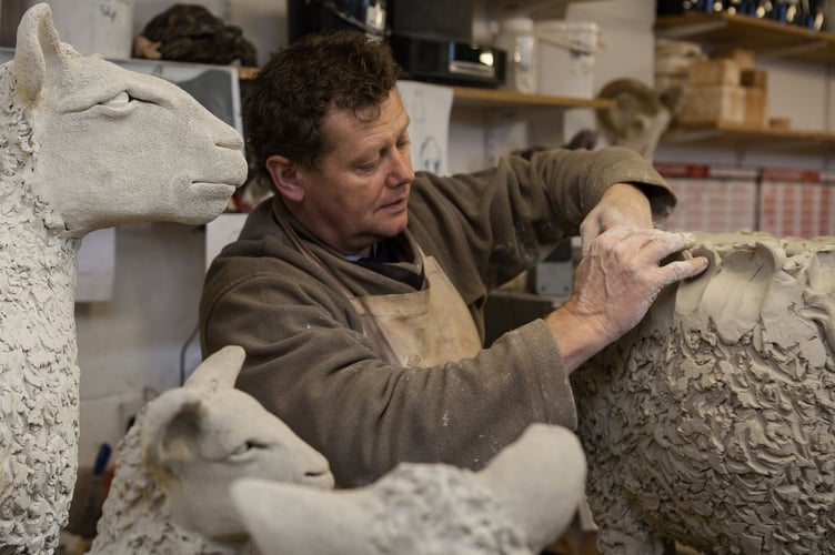 Jon Barrett-Danes sculpts clay sheep in his workshop near Alton, March 2026.