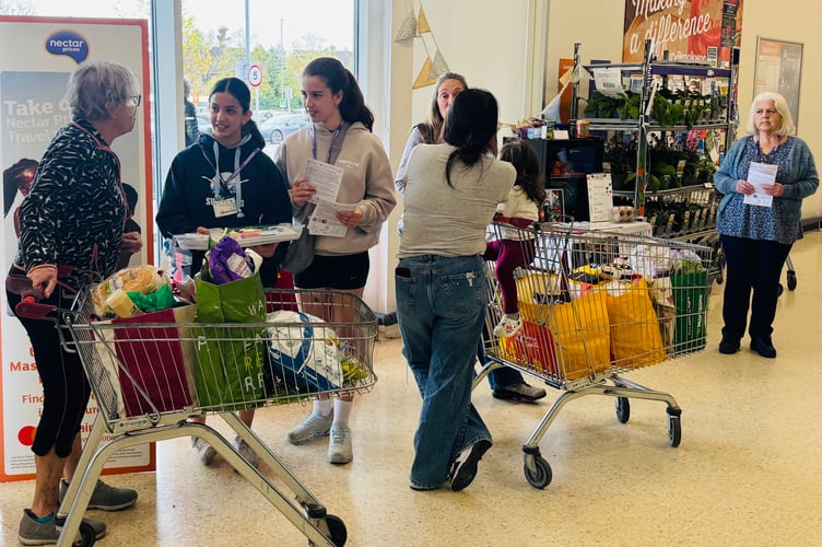 Juliet and her friend Sofia hand out cupcakes to Sainsbury's shoppers in Knaphill.