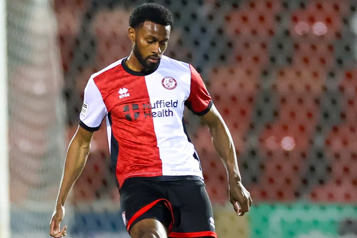 Woking defender Tunji Akinola signs new contract