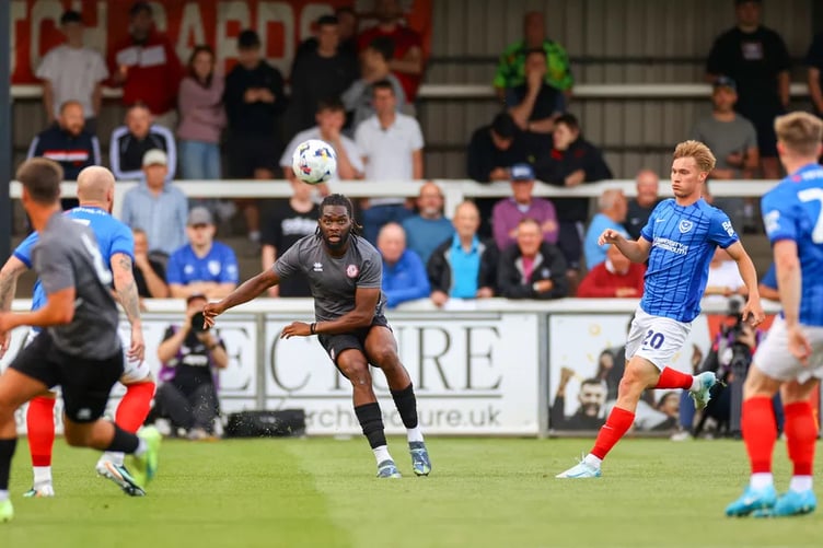 Chin Okoli clears the ball during Woking's 2-0 pre-season defeat against Portsmouth last summer (Photo: Phil Fiddes)