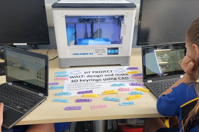 Year 6 children observing live 3D printing of their designs