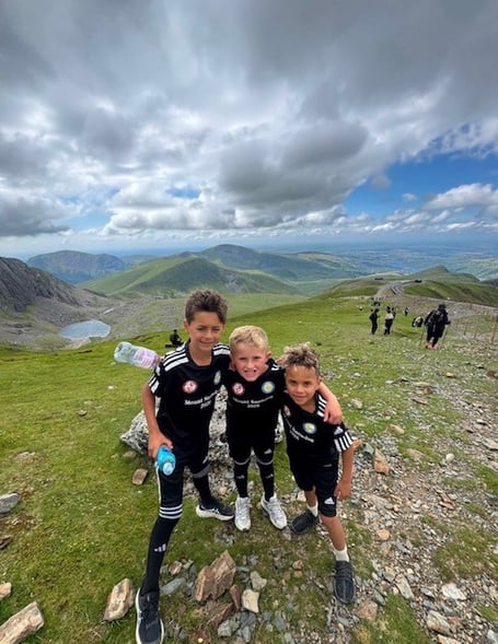 Best friends Jax Woodley, Antonio Schiavo and Abel Trafford completed the challenge of climbing Snowdon, raising enough to fund 74 children's counselling sessions at Woking & Sam Beare Hospice.