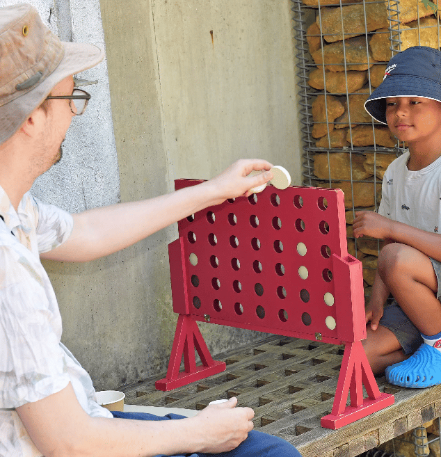 Man and boy playing Connect 4.