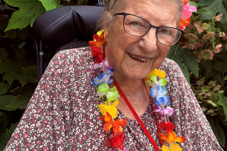 Bernard Sunley Resident, Barbara Watts, in her Hawaiian Lei enjoying the care home's Aloha Summer Fiesta
