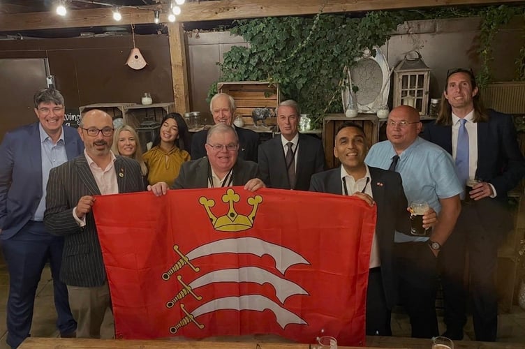 Cllr Harry Bopari with fellow councillors holding a Middlesex flag.