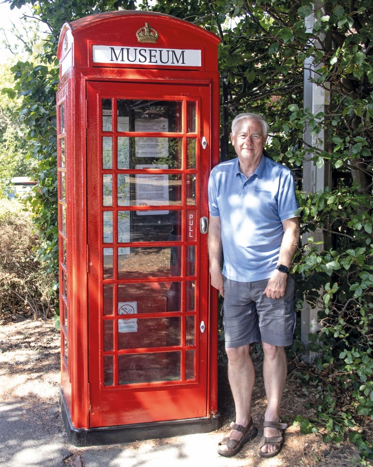 Chobham Museum volunteer Paul Reed with the old telephone box that has been restored with the help of a Chobham Carnival grant.