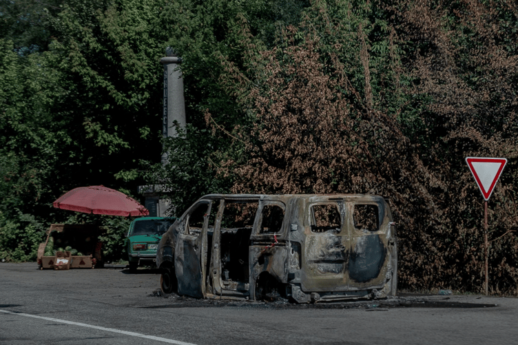 A burnt-out vehicle on a street in Zaporizhzhia, Ukraine, where the effects of the war are part of everyday life.