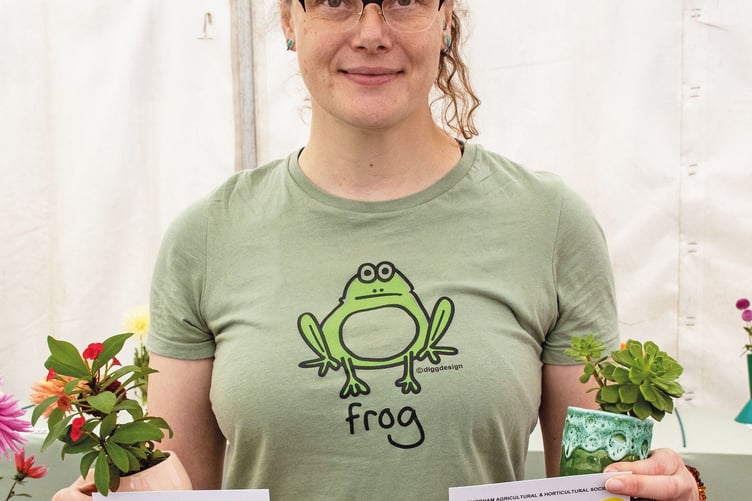 Ruth Papworth with her prizewinning blooming pot plant and succulent.